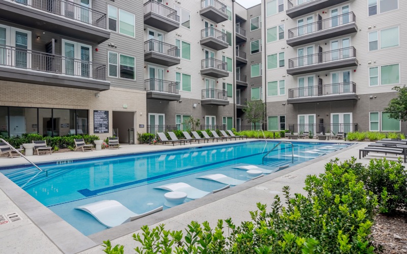 a pool with tables and chairs around it