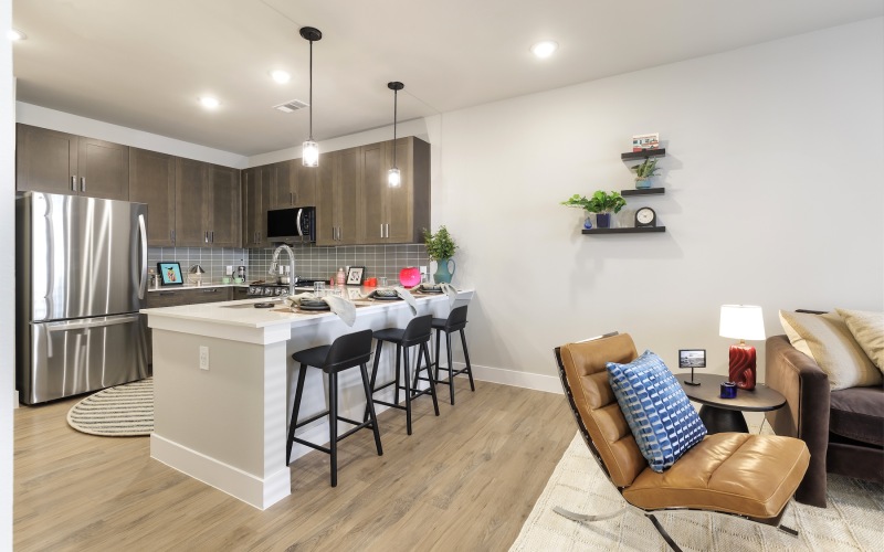 kitchen with brown cabinets island and couch