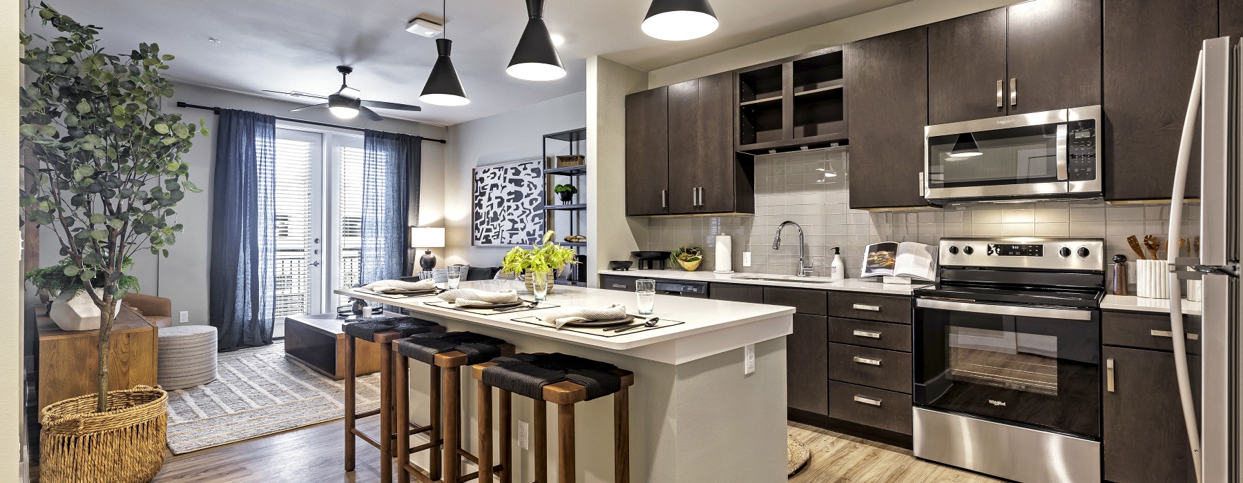 Apartment kitchen with stainless steel appliances at Urban East